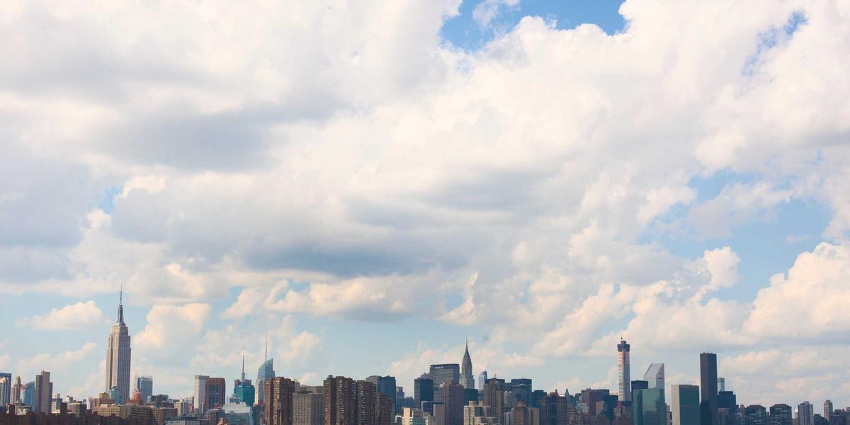 A city skyline under fast-moving clouds — the pace the web is judged against