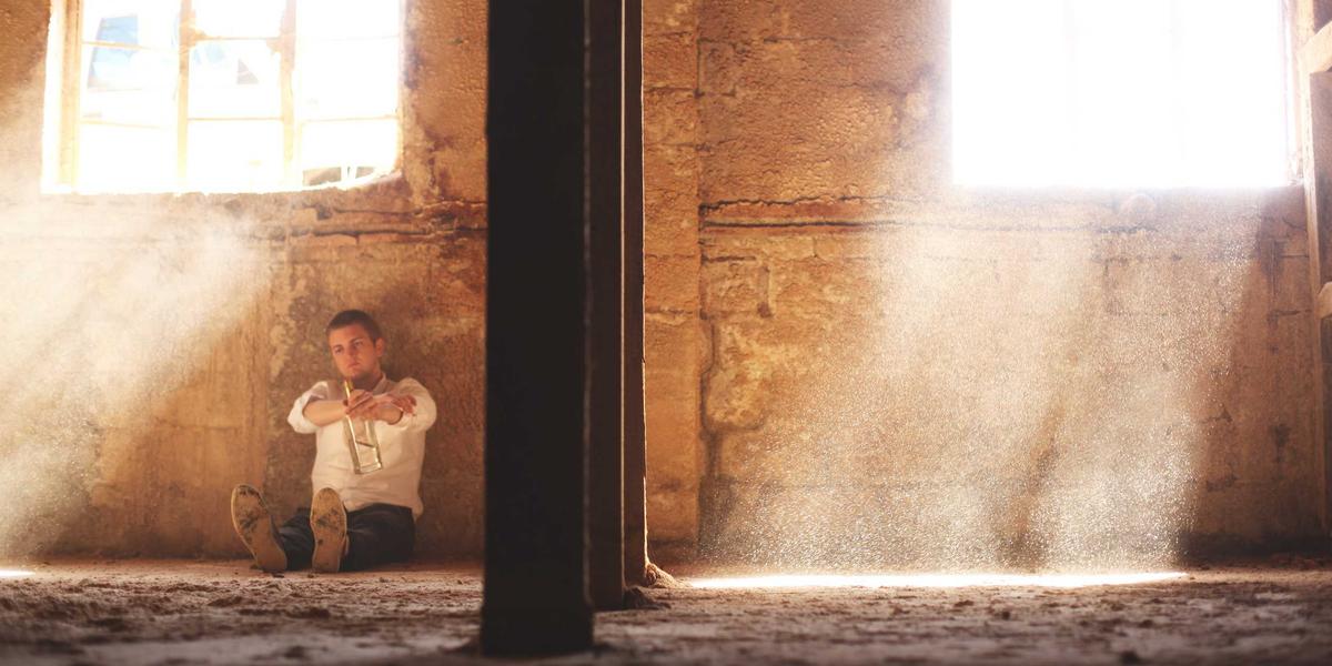 A person working in warm window light, absorbed at their keyboard — flow state in its natural habitat