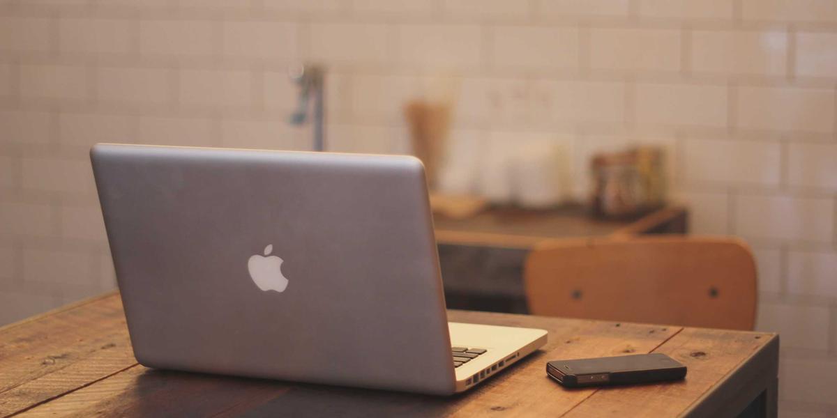 A minimal desk with a laptop — compress PDFs locally with no size caps