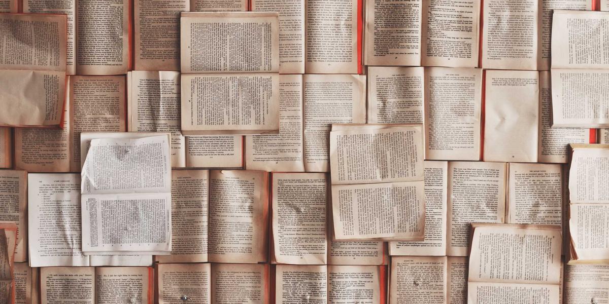 Fanned pages of old printed books — three decades of documents that had to open anywhere