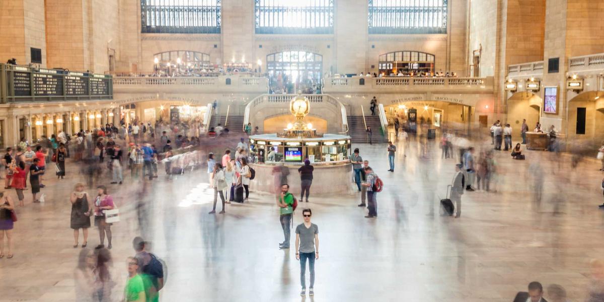 The vast interior of a grand central station — thousands of parallel journeys coordinated through one system
