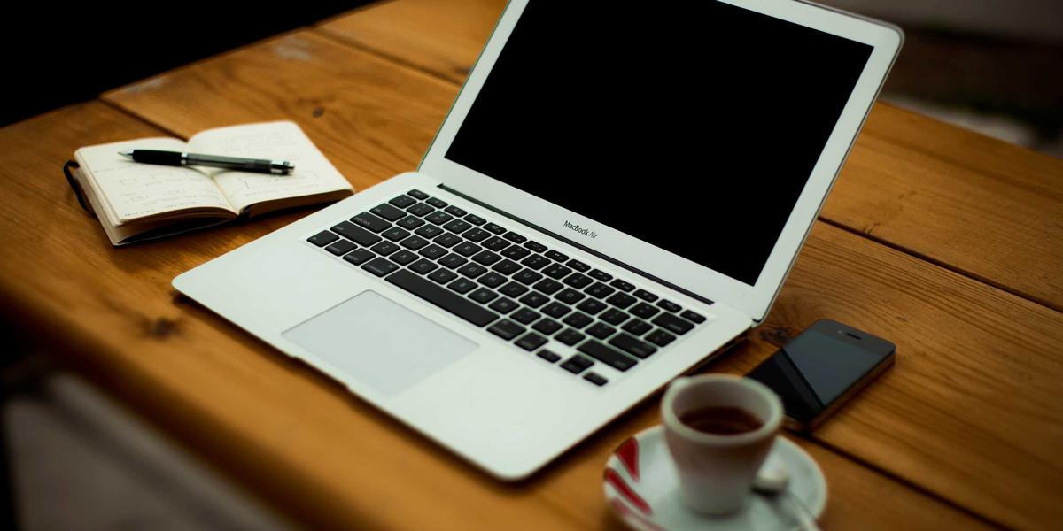 A laptop and coffee on a cafe table — progressive web apps keep working offline